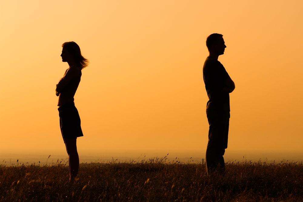Navigating the Divorce Process in Texas: A Comprehensive Guide - silhouette of man and woman at yellow sunset back to back